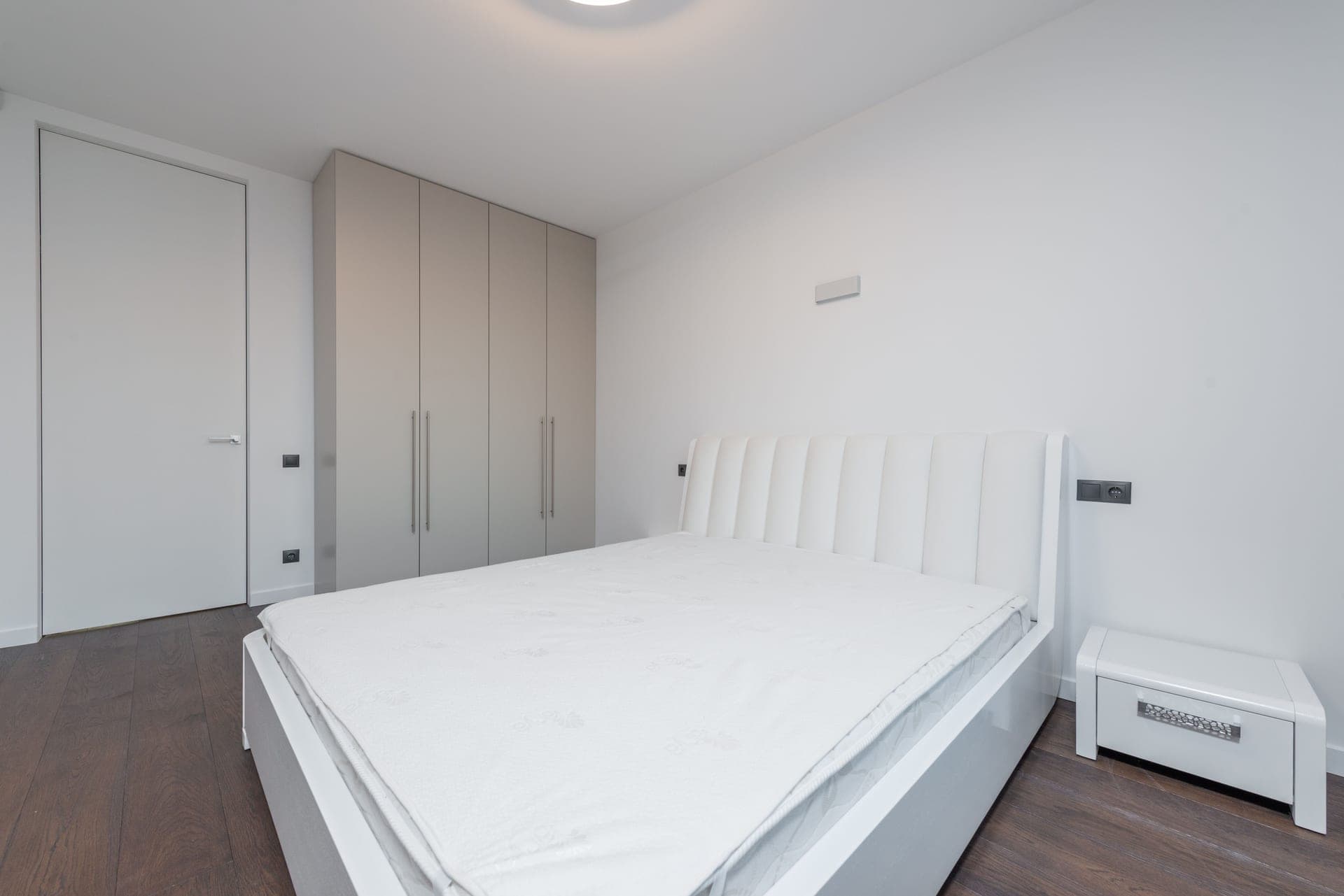 An adjustable bed raised at the head in a calm, sunlit bedroom