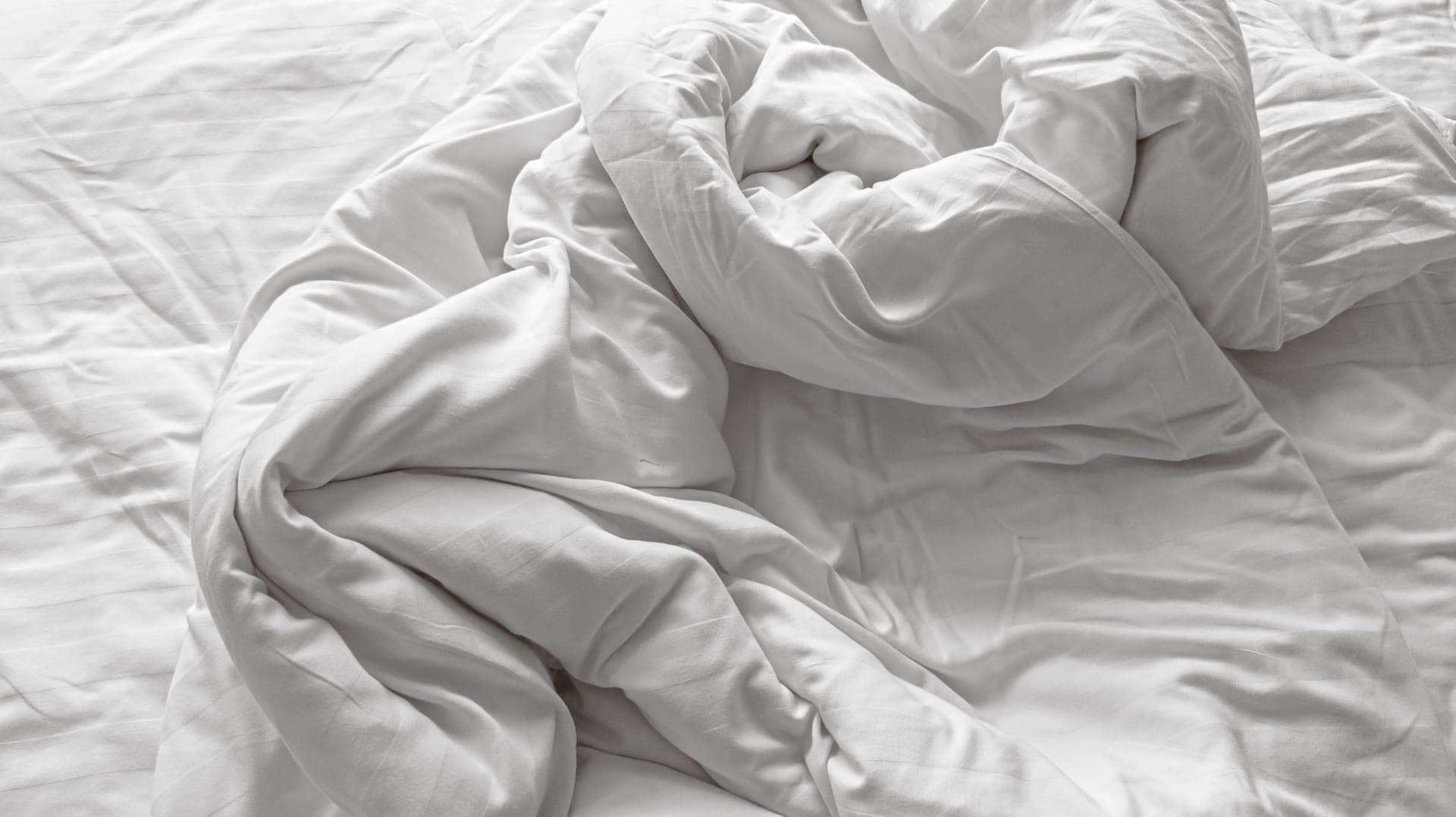 A close view of a clean mattress corner and natural cotton cover